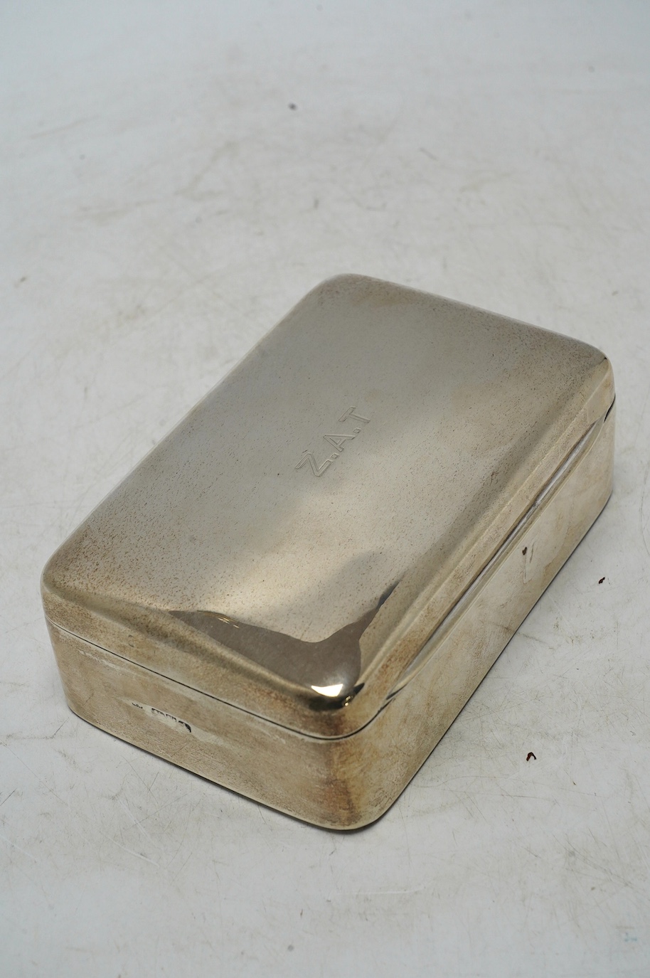 A George V? silver mounted cigarette box, marks rubbed, 13.4cm. Condition - poor to fair
